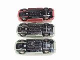 three toy cars that are sitting side by side on a white surface