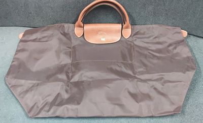 a brown bag sitting on the floor next to a blue carpet