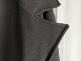 a close up of a coat hanging on a hanger