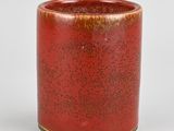 a red vase with a yellow rim on a white background