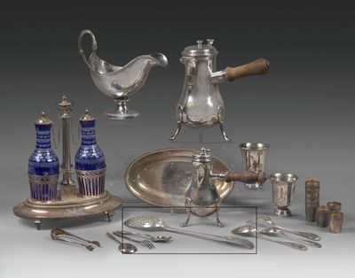 a silver plate and silverware on display on a table