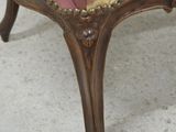 a pink and gold chair with a gold ribbon on it