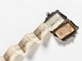 a bracelet that has a book on it that is attached to a chain