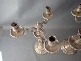 a silver chandelier that is on display on a table