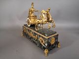 a statue of a man riding on a horse drawn carriage