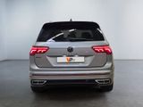 the rear end of a silver volkswagen v - cross parked in a white room