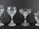 three clear glass goblets and an empty wine glass