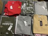 a lot of t - shirts that are sitting on a table