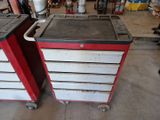 pair of red and white tool boxes sitting on top of each other