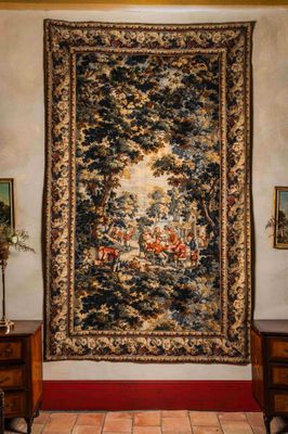 une grande tapisserie accrochée au mur dans un salon
