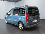 a small blue van that is parked in a room
