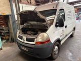 a white van with the hood open in a garage