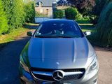 the mercedes cla is parked on the side of the road