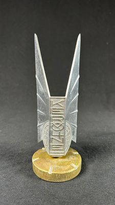 a close up of a small metal object on a black surface