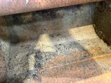 a rusted metal pipe with a hole in it