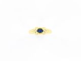 a yellow gold ring with a blue sapphire stone