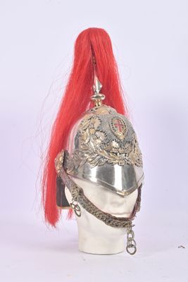 a silver helmet with red hair on top of a mannequin head