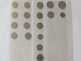 a lot of coins in a plastic container on a table