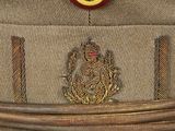 an image of a brown hat with a red eye on it