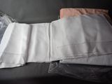 a folded sheet and a pillow on the couch