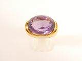an amethorate ring set in yellow gold with a purple amethorate