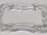 a clear glass tray with a decorative design on it