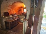 a kitchen with a stove and a sink in the middle of the room