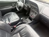 dashboard of a car with black leather seats and dashboard controls
