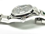 a close up of a watch on a metal bracelet