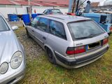 two cars parked next to each other in a yard