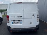 a white van parked in a parking lot next to a building