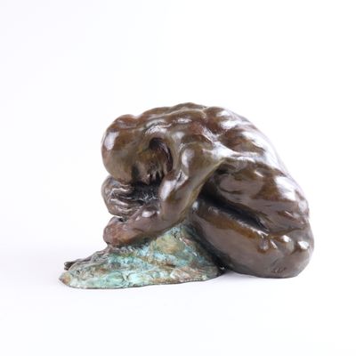 une statue représentant un singe assis sur un rocher