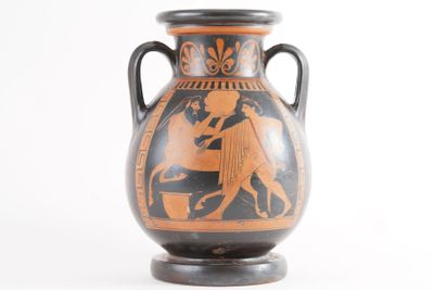 a vase with a black and orange design on it