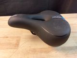 a close up of a bicycle seat on a wooden table