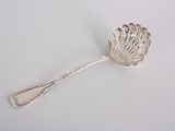 silver spoon with a leaf shaped handle on a white surface
