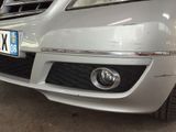 a silver car with a number plate on the front of it