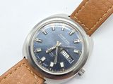 a close up of a watch on a white surface