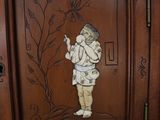 a wooden cabinet with a picture of a boy on it