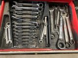 many wrenches in a red toolbox on the table