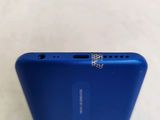the back of a blue cell phone with a diamond sticker on the back of it
