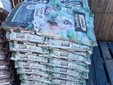 many bags of food sitting on top of pallets