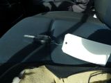 a cell phone sitting on a seat in the back of a car
