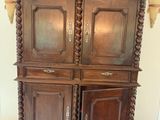 a large wooden cabinet with a door and a door handle