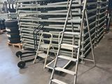 a group of ladders stacked on top of each other in a warehouse