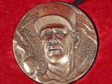 a picture of a medal with a picture of a baseball player on it