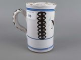 a coffee cup with a black and white design on it