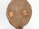 an old wooden object hanging on the wall