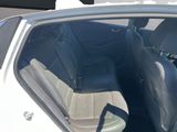 the back seat of a white car with the door open