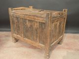 an old wooden chest on wheels on the floor
