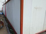 an image of a white and red building with a fire hydrant in front of it